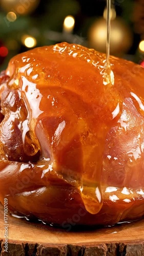 Close Up of Glazed Ham Being Drizzled with Honey Glaze With Christmas Decorations in Background Soft Bokeh Lights