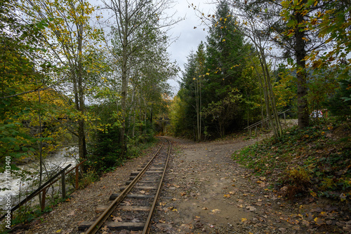 Narrow-gauge railway near the Mizunsky waterfalls on the Mizunka River. An old railway, a tourist route through a picturesque area. Autumn landscape.
