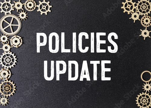 A black spiral bound notebook with the word Policies Update written on it.