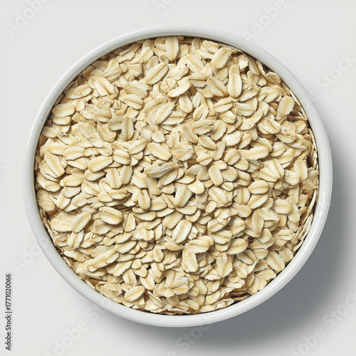White ceramic bowl filled with oat flakes, top view