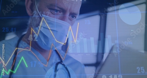 Reviewing doctor in scrubs viewing patient data in exam room, with stethoscope, charts, copy space