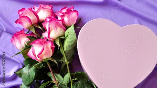 Pink roses and pink heart box.Valentines Day gifts.Romantic mockup with a bouquet of flowers and a gift box in lilac and pink shades. 4k footage