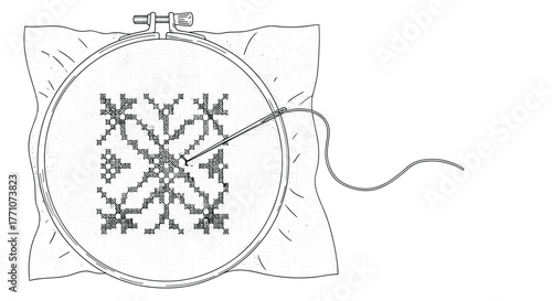 A craftsperson carefully cross-stitching an intricate snowflake pattern onto fabric held taut in an embroidery hoop, with needle and thread visible.