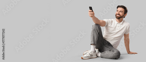 Happy man with remote contr...