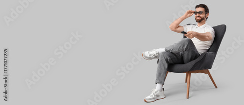 Happy man with remote contr...
