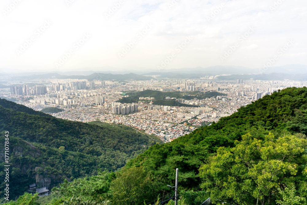 Obraz premium Daegu City, South Korea, September 26, 2025: Daegu Whole City View from Apsan Observatory after using Apsan Cable Car for City Panorama View with Apartments, Buildings, Mountains 대구 도시 전경 앞산 전망대 케이블카 