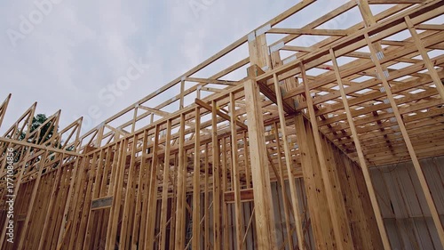 Wooden beams structures rise from ground, revealing new building framework