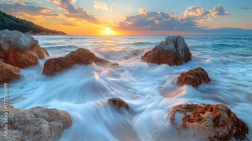 A beach with large rock formations and crashing ocean waves