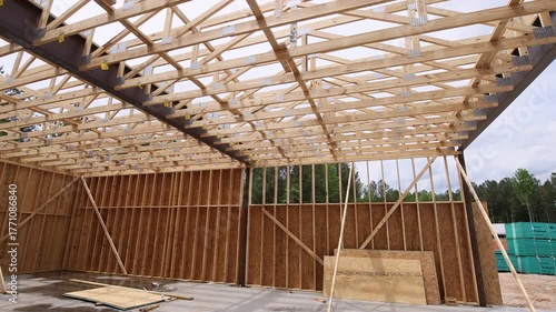 Wooden beams are being assembled to create roof structure of new building