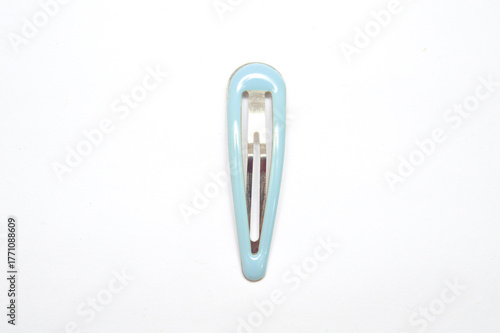 Close-up of a single light blue, glossy snap hair clip, barrette, isolated vertically on a pure white background. Represents beauty, fashion accessory, minimalist design, and childhood concept.