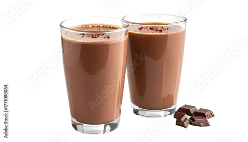 Two glasses of chocolate milk with cocoa powder garnish, and chocolate chunks on the side