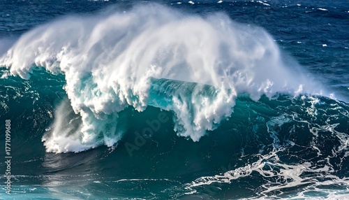 Fototapeta Naklejka Na Ścianę i Meble -  Captivating shot of a large, powerful ocean wave curling over, showcasing its frothy white crest and turquoise inner structure