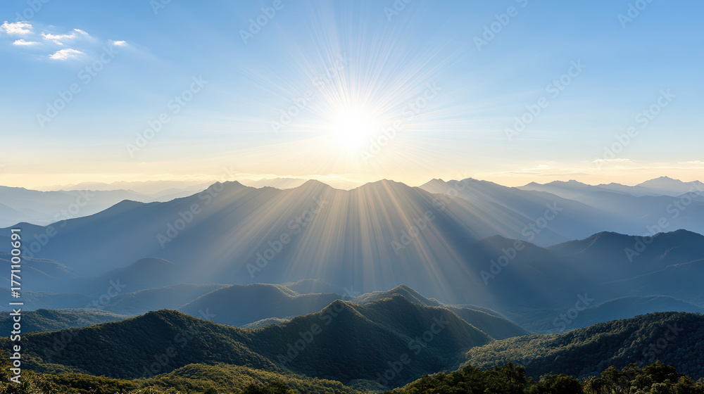 Obraz premium Sunlight scattering over layers of distant mountain ranges creates breathtaking view