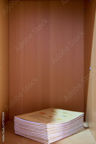 Single Book Leaning in Empty Wooden Shelf