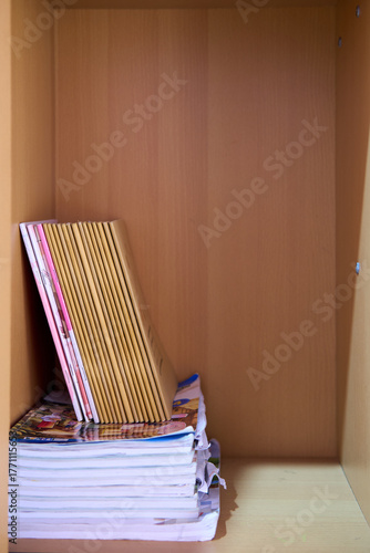 Various Books Stacked Neatly Inside a Wooden Shelf