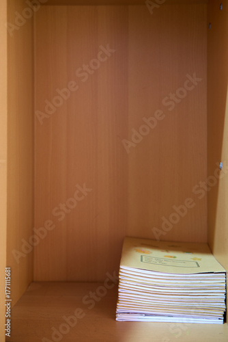 Single Book Leaning in Empty Wooden Shelf
