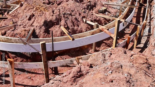 Set up wooden forms in preparation for pouring concrete at construction site under curbed is concrete installation
