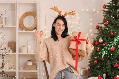 Young happy woman in deer h...