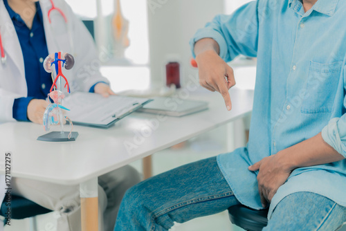 A young man goes to the doctor for a checkup for his health, sexual performance, and prostate cancer. The doctor then examines his penis for a tumor. Close-up.