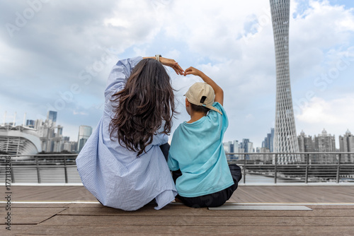 Mom and child compete for love in front of Guangzhou Tower