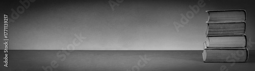 Stack of Vintage Books on a Subdued Gray Background