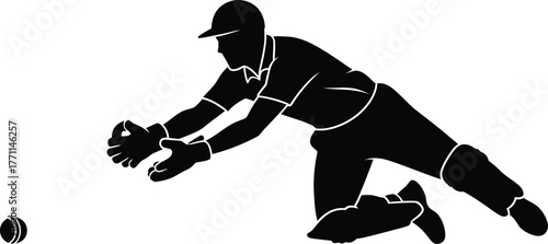 Baseball player diving to catch a ball in silhouette