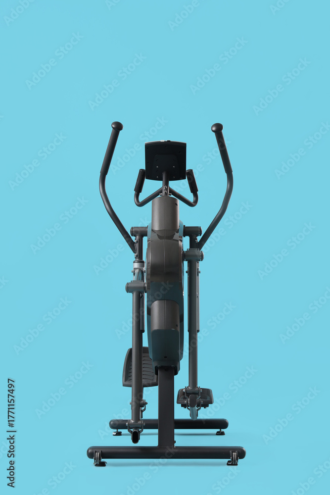 Naklejka premium Modern elliptical machine on blue background
