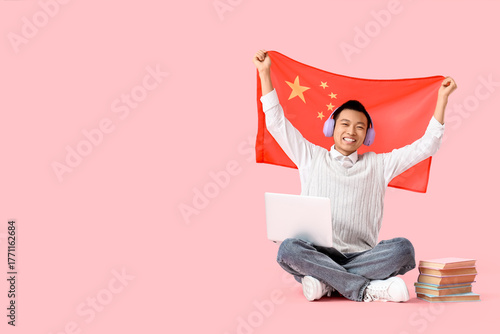 Young Asian man with flag o...
