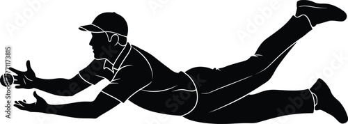 Baseball player diving to catch a ball in silhouette