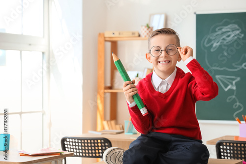Cute little schoolboy with ...