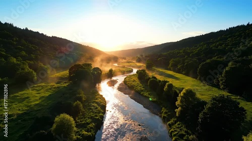 Aerial view of a winding river flowing through a lush green valley at sunrise goldenhour, view, environment
