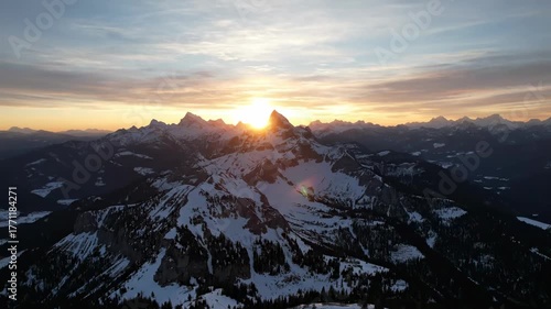 Drone flying forward over majestic mountain peaks at glorious sunrise wilderness, rock, serene