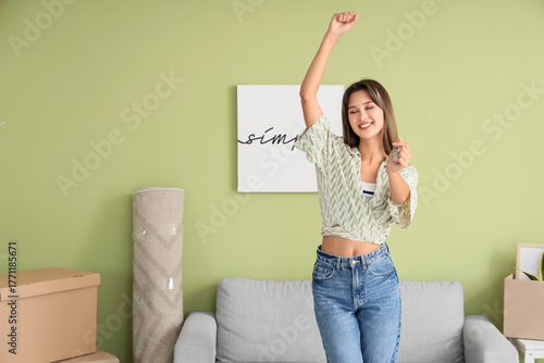 Happy young woman with keys...