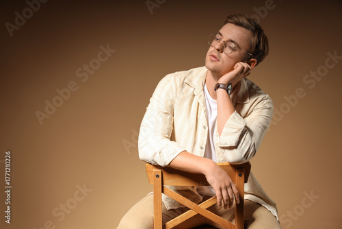 Stylish young man sitting i...