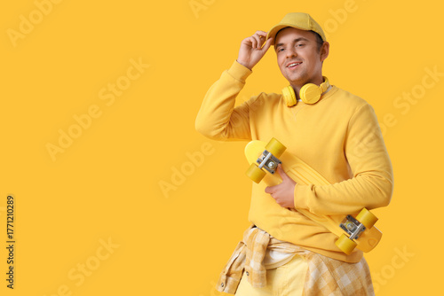 Stylish young man in cap wi...