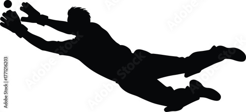 Silhouette of a soccer goalkeeper diving to make a save