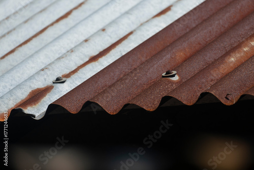 Close-up of a rusty, corrugated metal roof with brown and gray textures