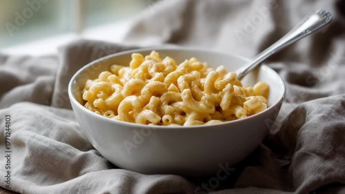 Creamy macaroni and cheese in a bowl, evokes comfort and warmth, perfect for cozy autumn meals or family gatherings