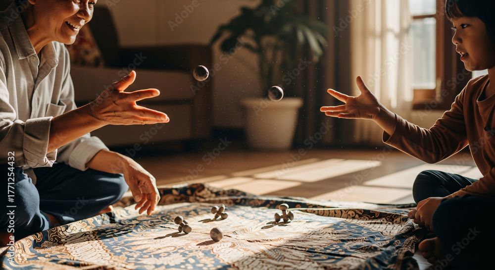 Obraz premium A grandparent and child playing five stones (traditional Southeast Asian game) in a warmly lit living room, mid-throw, with visible dust particles in the sunlight