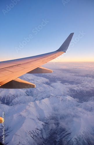 Caucasus mountains with snow peaks in aerial winter scene. Aerial view from plane.