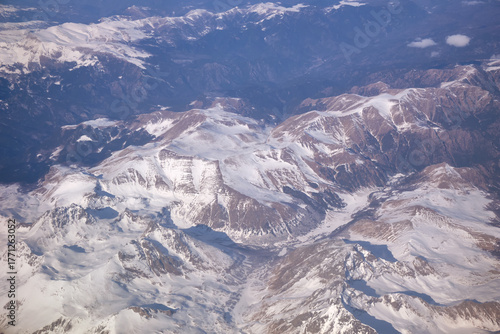 Caucasus mountains with snow peaks in aerial winter scene. Aerial view from plane.