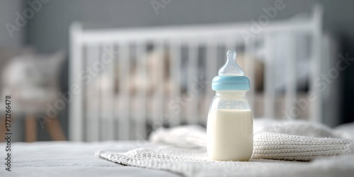 Baby bottle with milk on a white surface