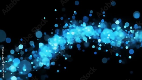 Blue glowing particle trail on dark background, abstract motion light effect 