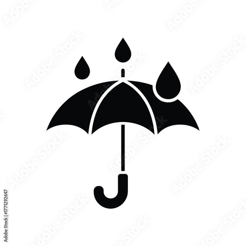Black silhouette of an umbrella with raindrops falling