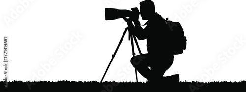 Silhouette of a dedicated nature and wildlife photographer with a telephoto lens on a tripod, capturing a special moment