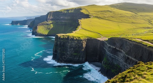 Aerial view of the cliffs of moher with green grass and blue ocean water