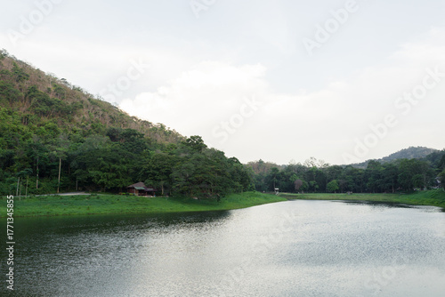 Tranquil view of Khao Ruak Reservoir and the small bungalow accommodation area within Namtok Sam Lan National Park, a popular spot for camping and relaxation in Saraburi, Thailand
