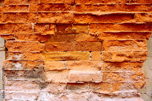 Close-up texture of aged, weathered bricks with visible signs of wear and degradation