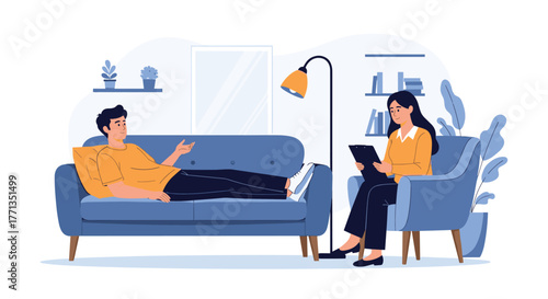 A male patient lies on a blue sofa, talking to a female therapist who is taking notes during a mental health therapy session.