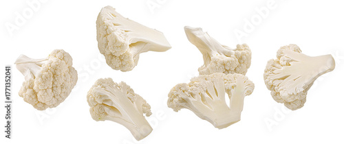 realistic photograph of a dense grouping of fresh, crisp white cauliflower florets and chunks, showcasing the texture and isolated cleanly on a solid black backdrop.
